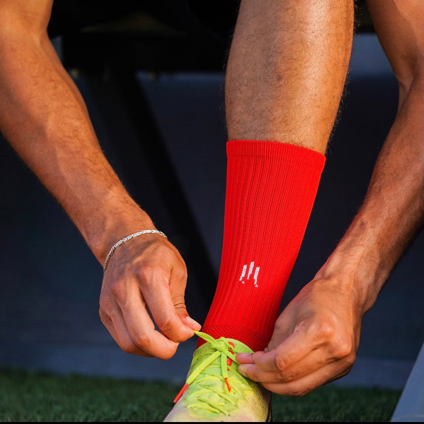 Chaussettes antidérapantes Tech Socks Rouge de la marque GLI TECH portées par un joueur